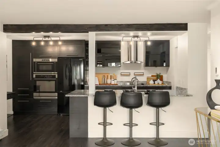 Beautifully remodeled kitchen with sprawling countertops with eat-up bar.