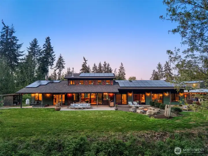 Main house has solar panels and back covered porch for entertaining and year-round enjoyment.