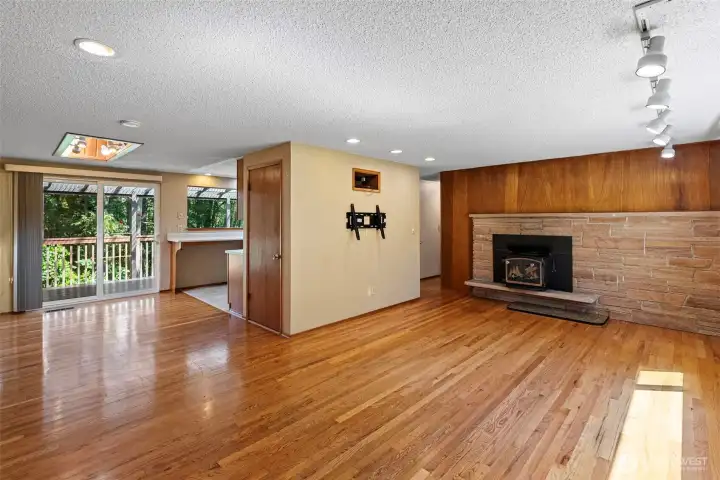 The living room flows seamlessly into the dining room with a sliding door to the expansive deck.