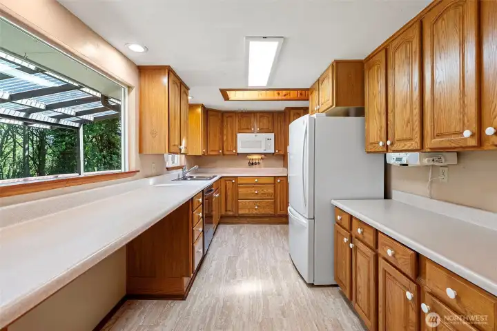 The kitchen has plenty of counter space and cabinetry and includes a perfect bar stool area looking out towards the territorial views.