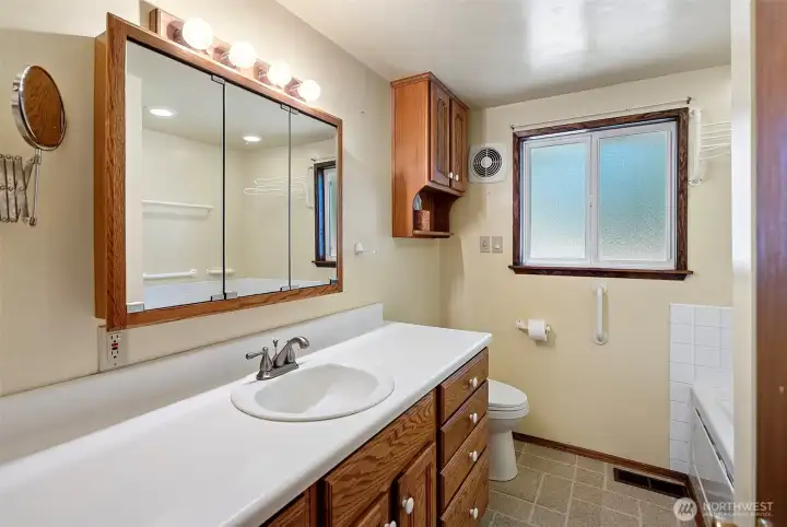 Inside, there are 1.75 baths, including this full bath with a jetted tub and separate shower.