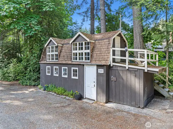 This cute building has workbenches inside as well as storage above.