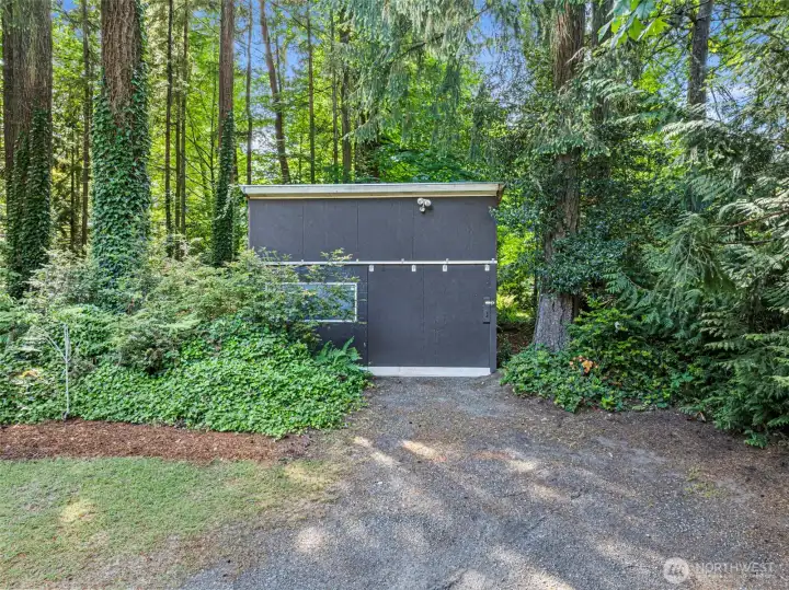 Another outbuilding is a perfect place to store a riding lawn mower and garden tools.