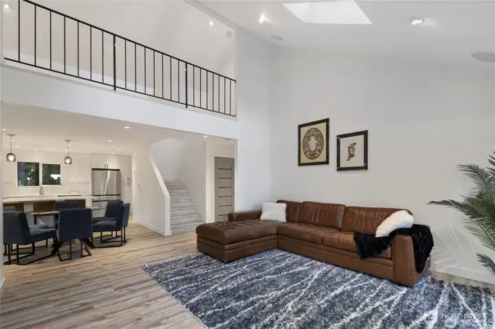 Vaulted ceilings, engineered hardwood floors, and an open dining-living design create a bright, welcoming main level with contemporary Northwest style. Vaulted ceilings, engineered hardwood floors, and an open dining-living design create a bright, welcoming main level with contemporary Northwest style.