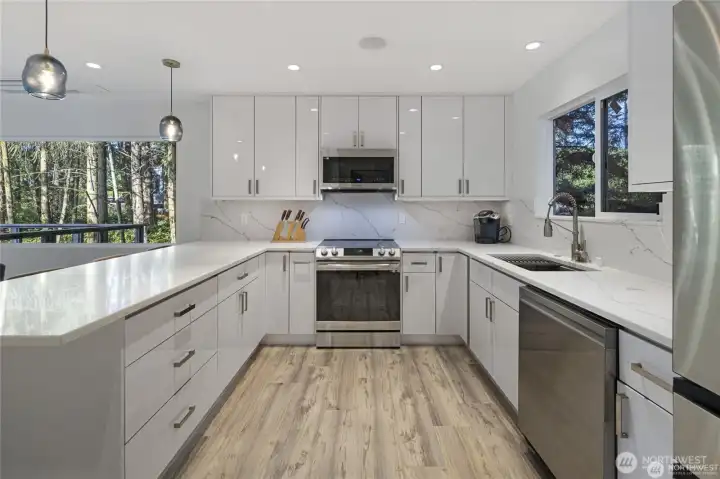 The remodeled kitchen showcases sleek white cabinetry, quartz-style countertops, stainless steel appliances, and a bright modern design ideal for island living. The remodeled kitchen showcases sleek white cabinetry, quartz-style countertops, stainless steel appliances, and a bright modern design ideal for island living.