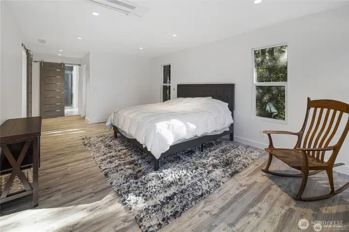 The spacious primary suite features engineered hardwood floors, soft natural light, ductless heat, and a private connection to a beautifully updated bath. The spacious primary suite features engineered hardwood floors, soft natural light, ductless heat, and a private connection to a beautifully updated bath.