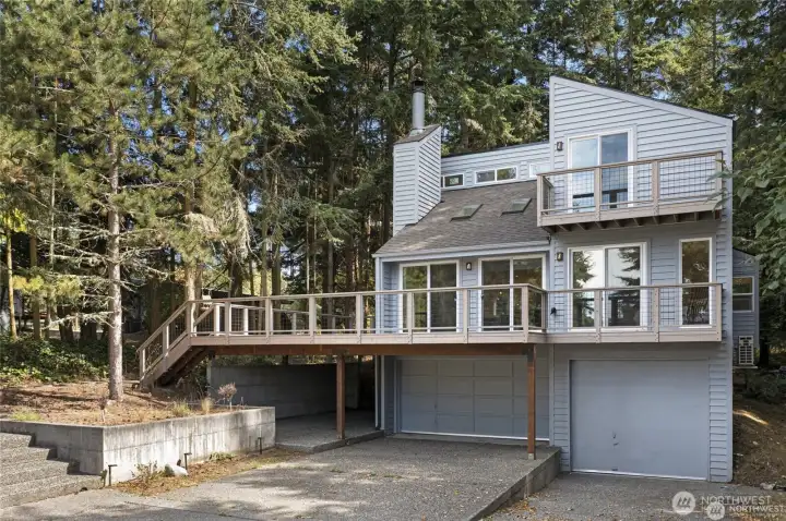 A spacious driveway and garage provide practical everyday convenience, with room for island gear, vehicles, kayaks, bikes, or boating accessories. A spacious driveway and garage provide practical everyday convenience, with room for island gear, vehicles, kayaks, bikes, or boating accessories.