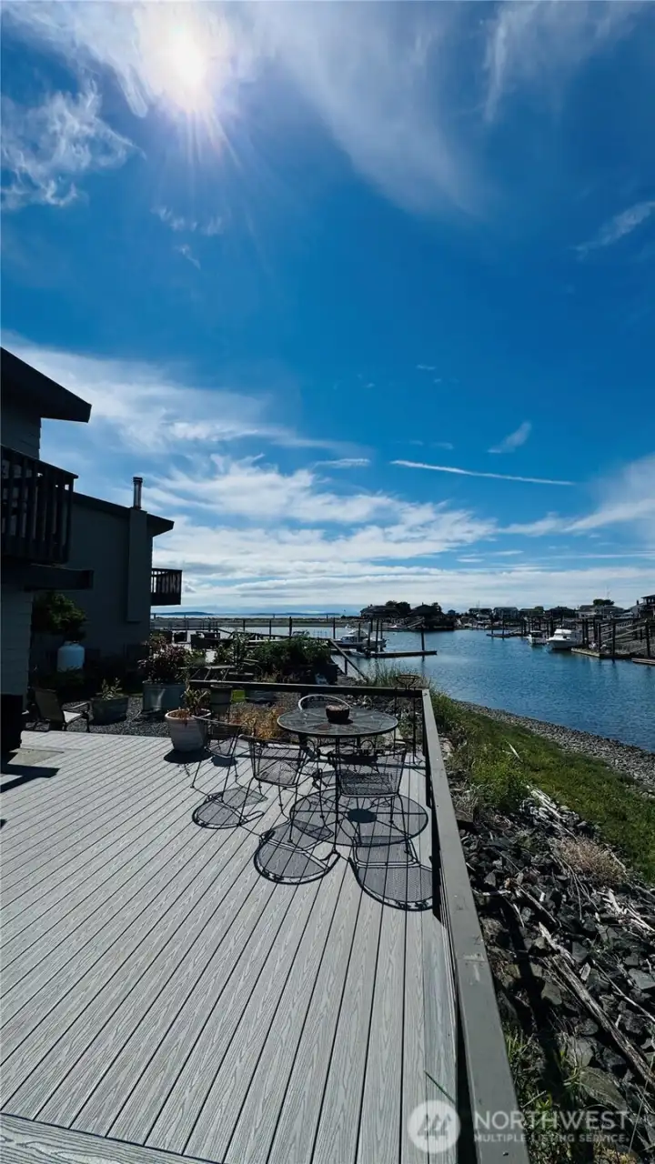 This is the main level deck view towards the open water of the Puget Sound and the included moorage slip. This is the main level deck view towards the open water of the Puget Sound and the included moorage slip.