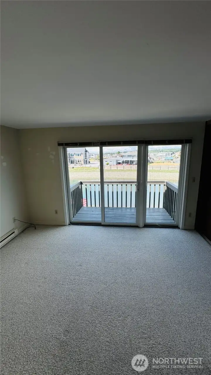 Upper level primary water side bedroom with large view deck... Upper level primary water side bedroom with large view deck...