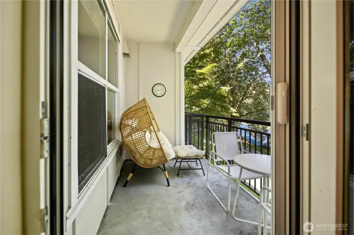 Private balcony with leafy views and space for outdoor seating. Private balcony with leafy views and space for outdoor seating.