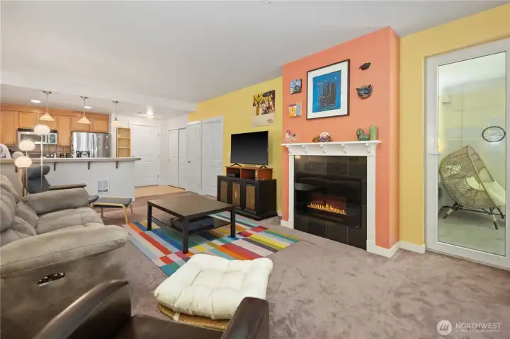 Living room with electric fireplace and access to the private patio. Living room with electric fireplace and access to the private patio.