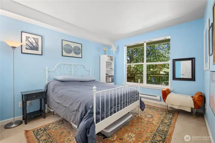 Bright primary bedroom with a large window, leafy views, and space for comfortable everyday living. Bright primary bedroom with a large window, leafy views, and space for comfortable everyday living.