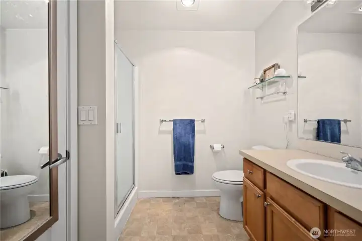 Full bathroom with glass shower doors and neutral finishes. Full bathroom with glass shower doors and neutral finishes.