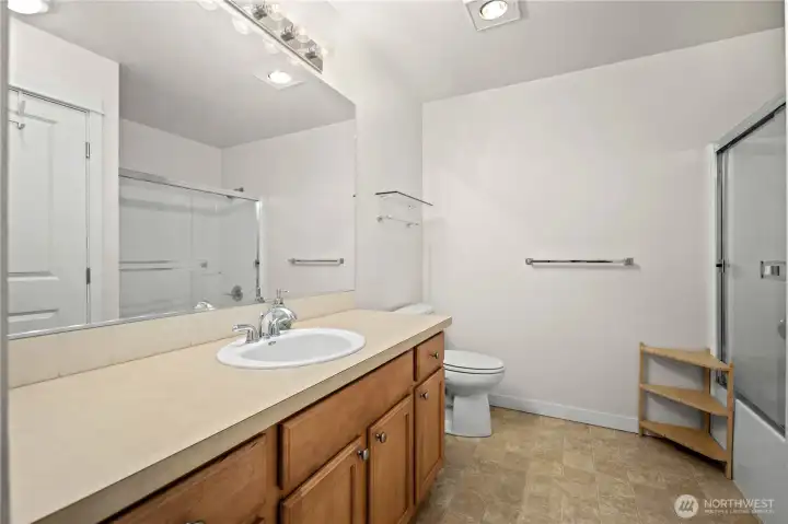 Full bathroom with an extended vanity, large mirror, and tub-shower combination for everyday convenience. Full bathroom with an extended vanity, large mirror, and tub-shower combination for everyday convenience.