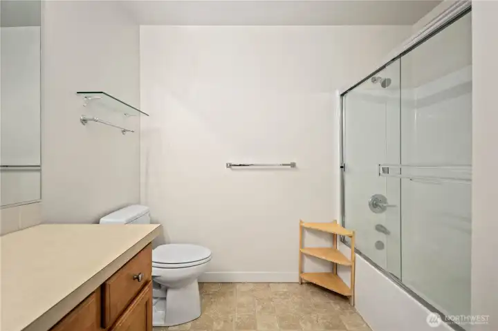 Full bathroom with glass shower doors and neutral finishes. Full bathroom with glass shower doors and neutral finishes.