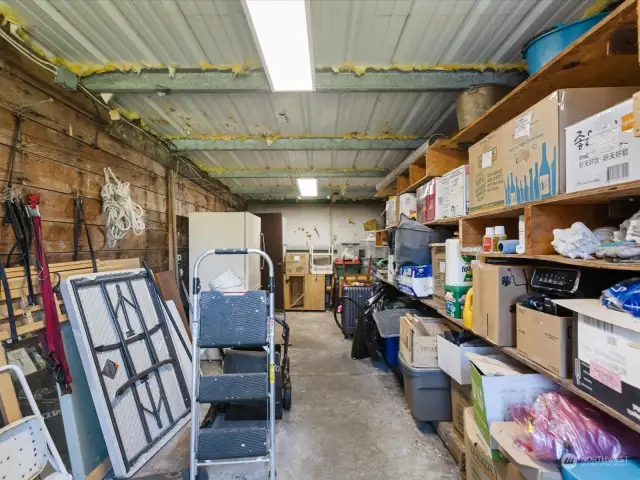 Walk to the back and turn left - you will find a huge gardener's space or mechanics workarea complete with work bench.