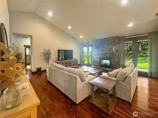 The spacious living room is anchored by a statement fireplace and seamlessly flows into the dining area, ideal for both intimate gatherings and entertaining.