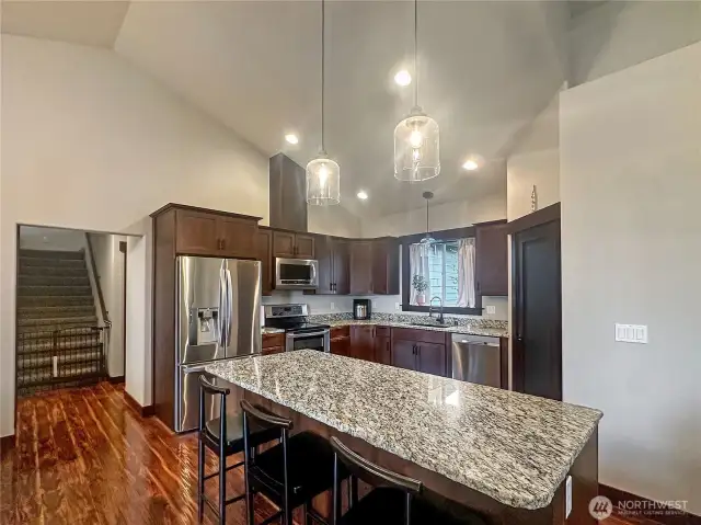The gourmet kitchen is a chef’s dream, featuring top-of-the-line appliances, a large quartz island, designer features.