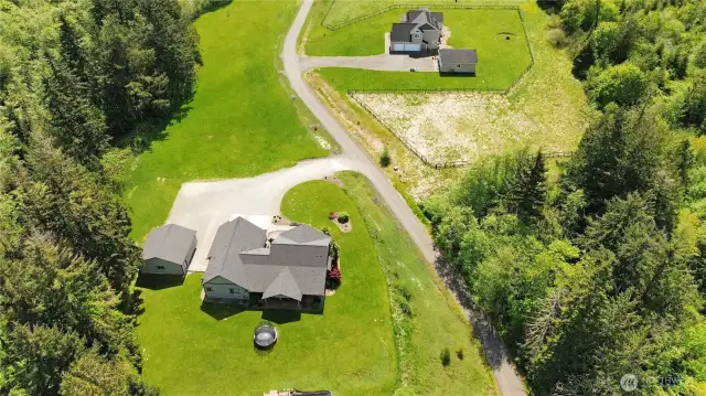 Experience the best of both worlds: a private, tree-lined sanctuary just a short drive from shops, dining, and schools.  virtually enhanced grass