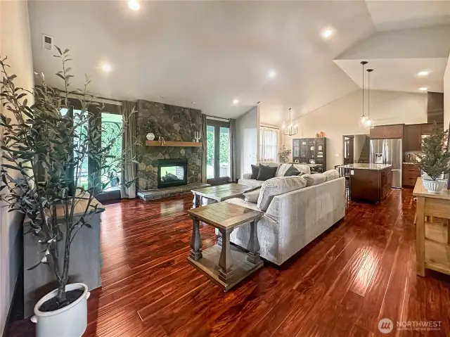 Expansive windows throughout the home flood the space with natural light and offer panoramic views of the surrounding landscape.