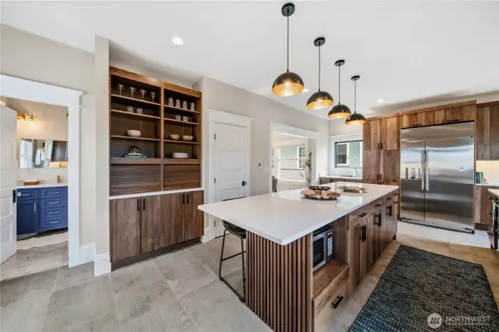The custom kitchen is next level for all your chef and entertaining needs. The massive island doubles as a gathering place with plenty of seating.