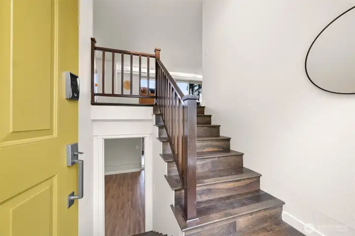 Warm and welcoming entry, with newer engineered hardwood floors and fresh interior paint