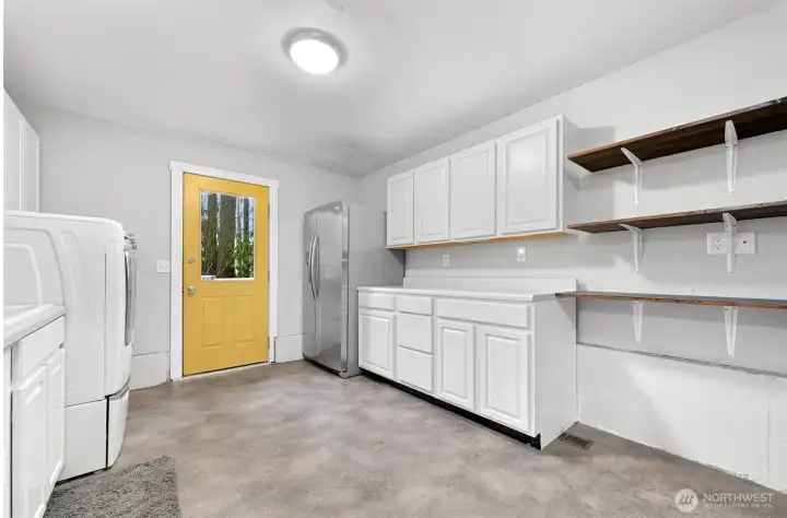 The second ADU entrance facing the backyard and trail. This area has a refrigerater, sink, counter and storage space, and a washer/dryer.