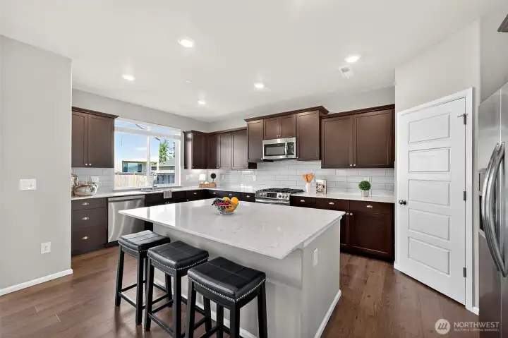 The kitchen island has storage AND extra seating