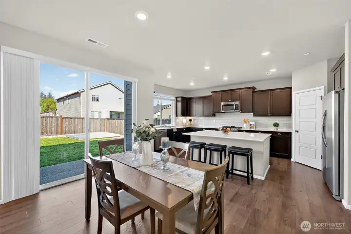 Sliding glass doors lead to the covered patio & large backyard