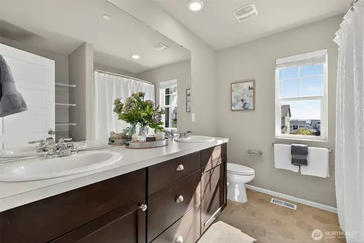 Lovely guest bath has a Tub & Shower, & extra linen storage
