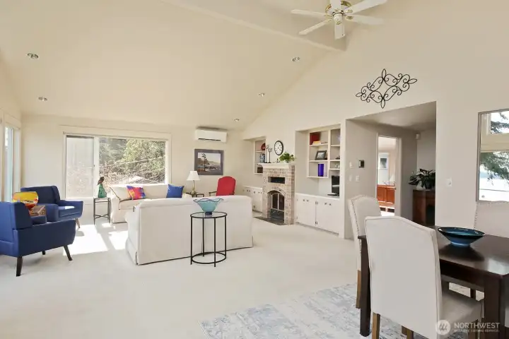 Living and dining area with a cozy fireplace.
