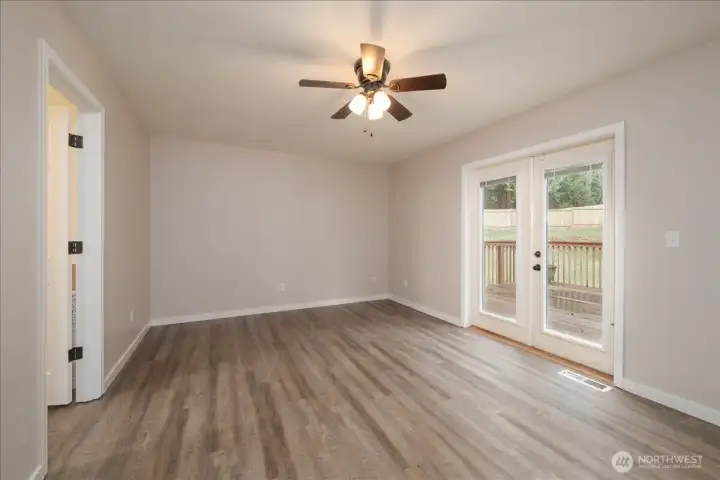 Main house: Primary bedroom with ensuite and French door access to deck on main floor.