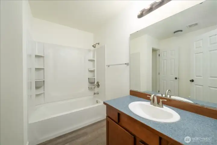 Main house: Upper level full bathroom with walk-in-closet.