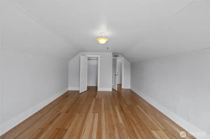Upper level south facing bedroom#1 with gorgeous refinished fir floors!