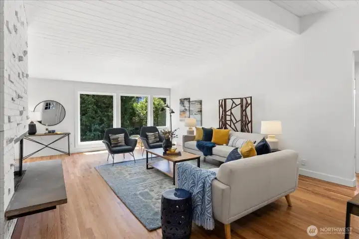 Comfortable living room filled with natural light and warm hardwood floors