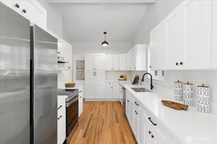 Sleek stainless appliances and crisp white cabinetry create a fresh modern feel