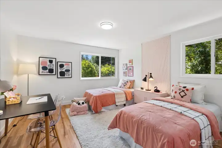 Spacious secondary bedroom with soft natural light and updated flooring