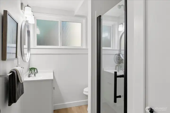 Updated bath with contemporary finishes and stylish black accents