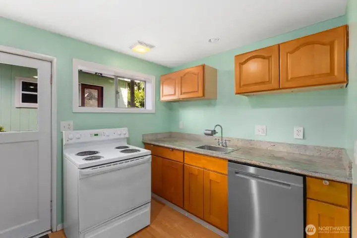 Lower level kitchen features oven/range, sink, dishwasher, fridge, microwave and ample cabinet storage