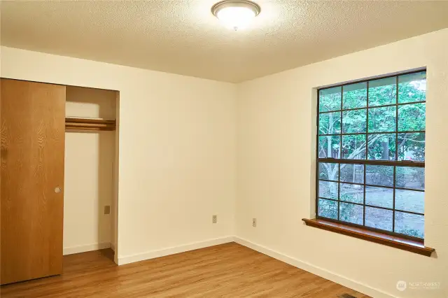 2nd Bedroom with huge window and view from landscaped backyard.