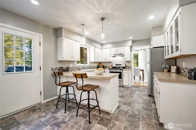 Kitchen with breakfast bar.  Door leads to deck