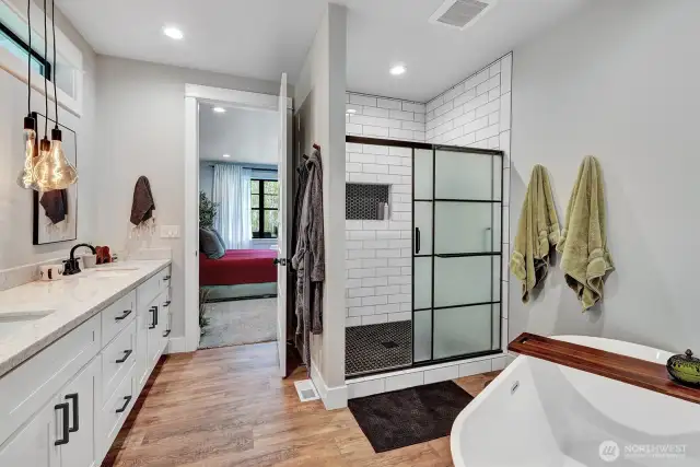 Ample vanity space, and thoughtfully designed lighting that creates a serene ambiance. Beautifully tiled shower with glass enclosure adds a touch of contemporary elegance.