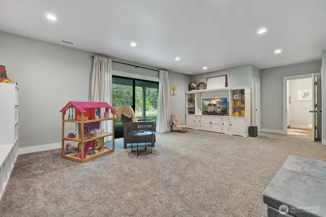 This spacious family room becomes a versatile hub, offering a comfortable retreat with easy access to your outdoor oasis, making it ideal for gatherings and everyday enjoyment.