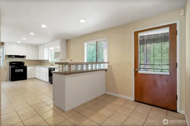 Large kitchen with tile floor and eating bar