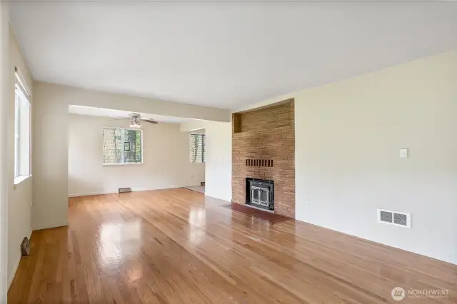 Living Room with hardwood floors, fireplace and open to dining area