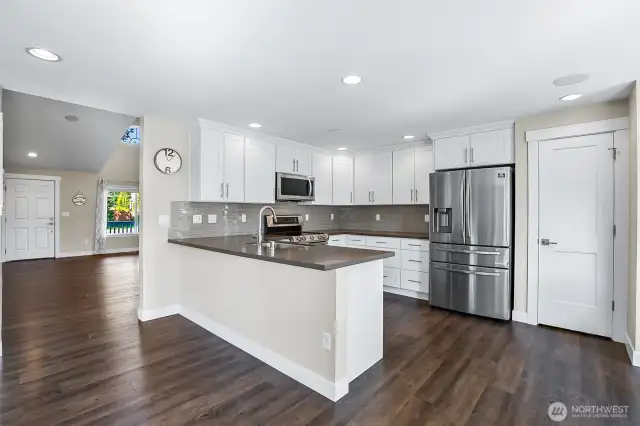 The kitchen has been refreshed with white cabinetry and Quartz surfaces.