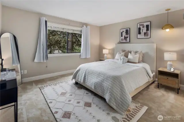 Spacious primary bedroom offers respite at the end of the day.