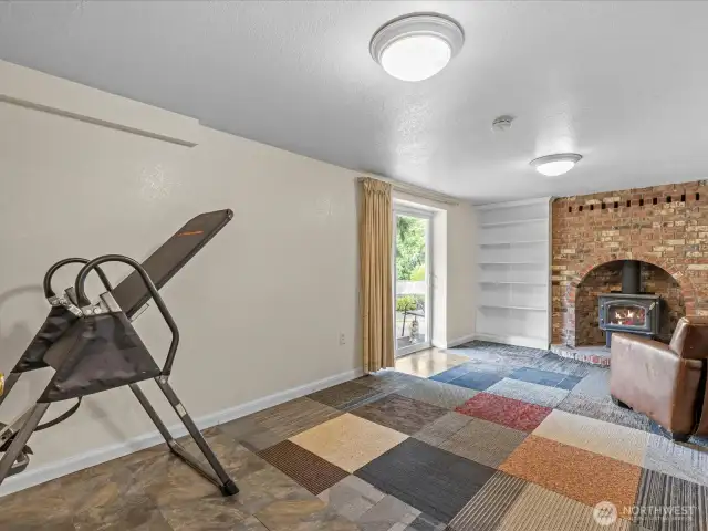 The Rec Room has sliders that go out to the back yard.  Note the woodstove.  There is plenty of seasoned wood for the woodstove being left on the property.