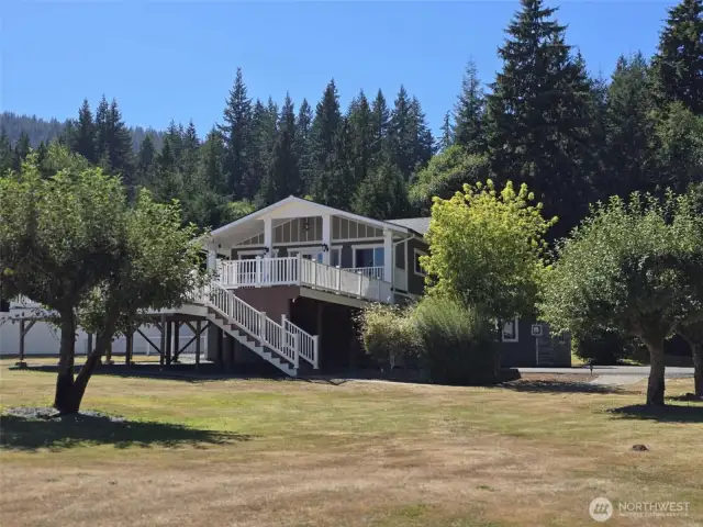 Viewing this beautiful home and yard from the campground like woods. You are sure to get to know the local deer as they bring their little ones around every year to the 5 apple trees in the yard.