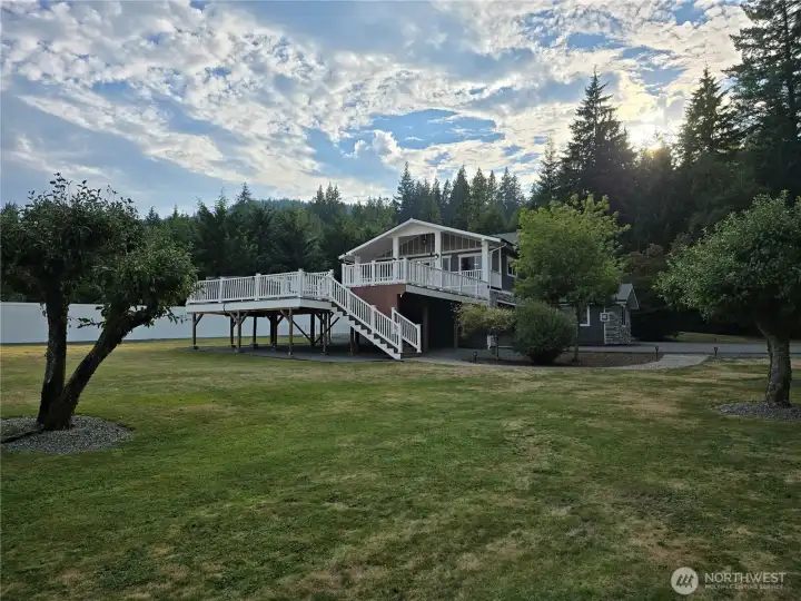 Viewing this beautiful home and yard from the campground like woods. You are sure to get to know the local deer as they bring their little ones around every year to the 5 apple trees in the yard.